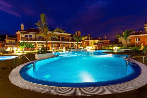 a large swimming pool in a resort at night at Luxury Apartment in Monte Carrera , Arguineguin in La Playa de Arguineguín