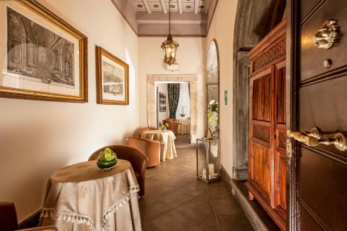 a hallway with a table and chairs in a room at Dimora Degli Dei in Rome