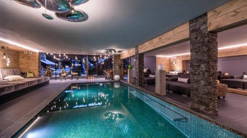 a large swimming pool in a hotel room at Alpin Garden Luxury Maison - Adults Only in Ortisei