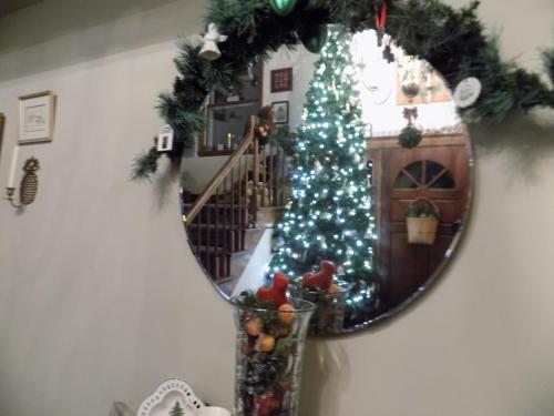 a christmas tree in front of a mirror at StoneWall House in Lake Elmo