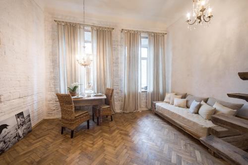 a living room with a couch and a table at Overture Studio in Kamianets-Podilskyi