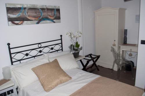 a bedroom with a white bed with a pillow on it at Carpe Diem Countryhouse in Cesarolo