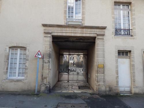 an entrance to a building with a large metal gate at Au cœur du centre historique in Bayeux