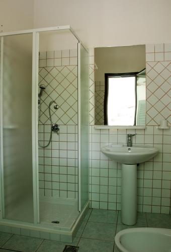 a bathroom with a sink and a shower at Residence Cort'e Accas in Bari Sardo