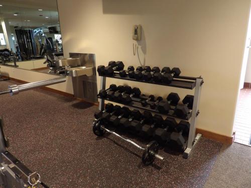 a gym with a rack of weights at Hotel Mission De Oro in Santa Nella Village