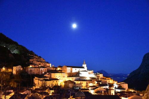 a view of a town at night with the moon at B&B "LA GIANCARLA" in Maratea