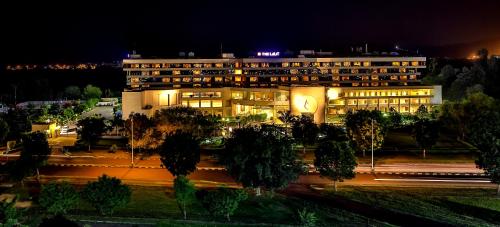a building at night with a street in front of it at The Lalit Chandigarh in Chandīgarh