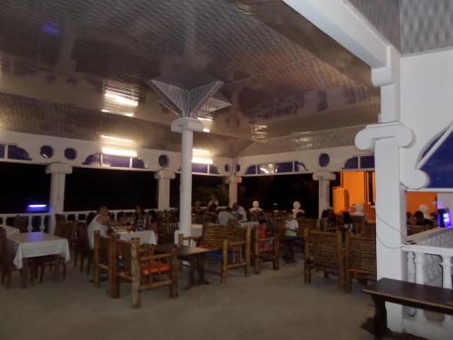 uma sala de jantar com pessoas sentadas em mesas e cadeiras em Saba em Shekhvetili