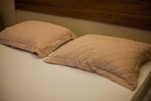 a bed with two pillows on top of it at Portal Da Praia Hotel in Fortaleza