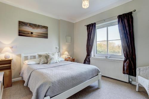 A bed or beds in a room at South Norfolk Guest House 