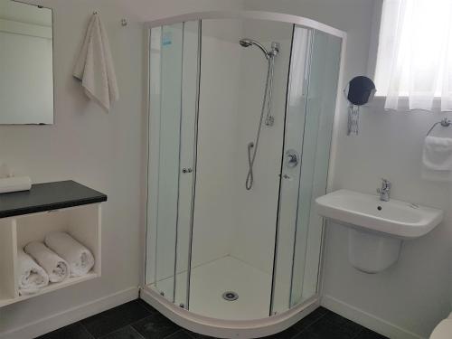 a bathroom with a shower and a sink at Vista Motor Lodge in Wairoa