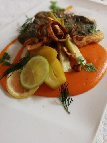 a plate of food with shrimp and vegetables on it at Le Cheval Blanc in Jargeau