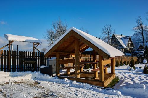 a wooden gazebo with snow on it at Willa Chrycówka - Jacuzzi, Basen, Sauna in Kościelisko