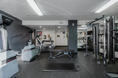 a gym with treadmills and machines in a room at Hotel Faubourg Montreal Centre-Ville Downtown in Montréal