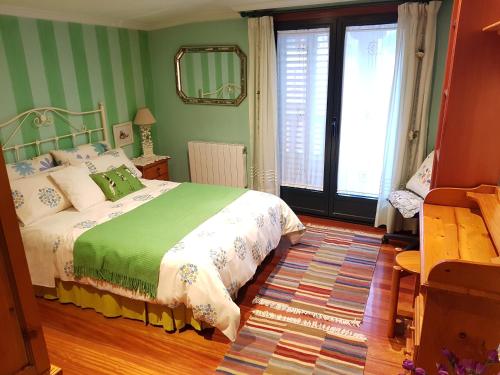 a bedroom with a bed and a large window at Virginia Redondela in Redondela