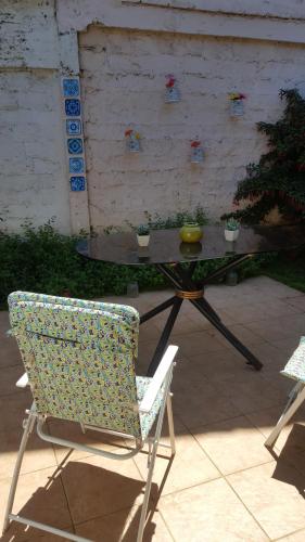 Hospedaje Myrtha في تيموكو: كرسي وطاولة عليها صحن