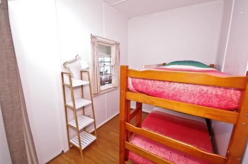 a bedroom with two bunk beds and a mirror at Bella Vista, 9 East Street in Crescent Head
