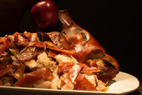 a pile of food on a plate with an apple at Luxent Hotel in Manila