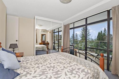 a bedroom with a bed and a large window at Tasman Towers 9 3 Munster Street Port Macquarie in Port Macquarie