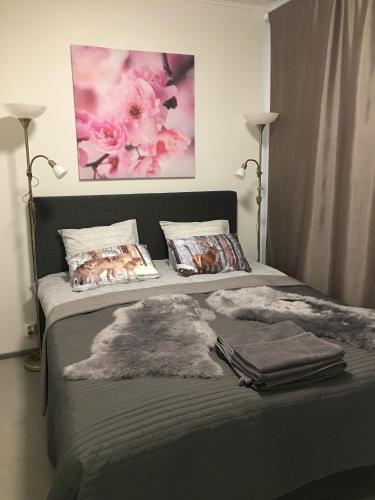 a bedroom with a bed with a blanket and flowers at Arctic Resort Delight in Rovaniemi