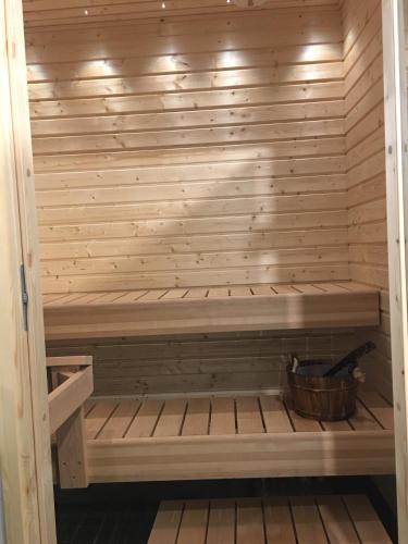 a sauna with a bench in a wooden wall at Arctic Resort Delight in Rovaniemi