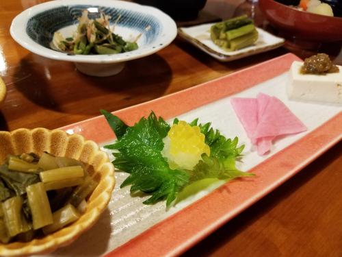 a plate of food on a table with a plate of food at Ryokan Yamakanoyu in Kiso