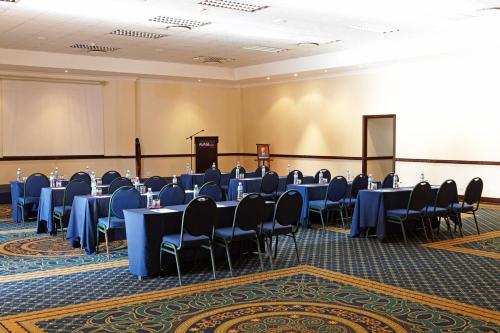 a conference room with tables and chairs in it at Avani Pemba Beach Hotel in Pemba