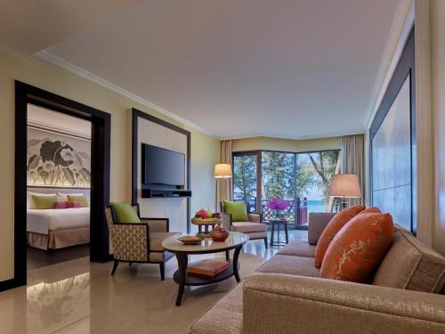 a living room with a couch and a table at Dusit Thani Laguna Phuket in Bang Tao Beach