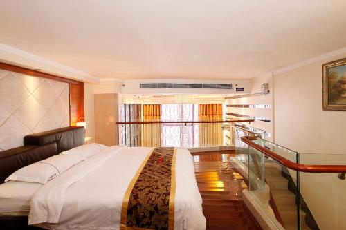 a bedroom with a large bed and a glass staircase at Guangzhou Hakka Apartment Beijing Road in Guangzhou