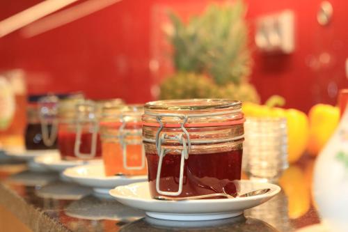 a mason jar of honey on a counter with plates at Gasthof Sempt in Spörerau