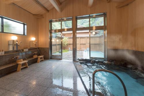 a bathroom with a jacuzzi tub in a building at Yunotani Senkei in Totsukawa
