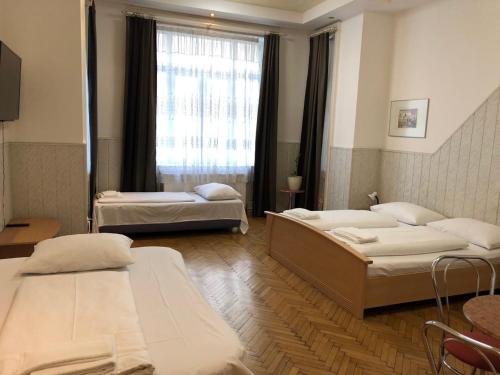 a hospital room with two beds and a window at Pension Vera in Vienna