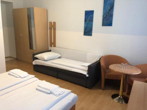 a hospital room with two beds and a table at Pension Vera in Vienna