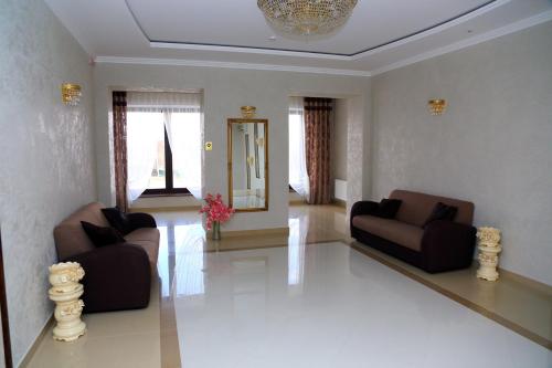 a living room with two couches and a mirror at BeSt Hotel and Restaurant complex in Dunaivtsi