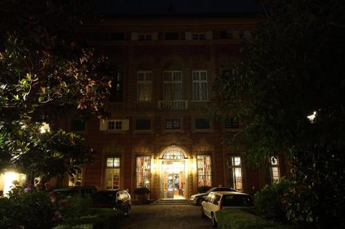 a large building with cars parked in front of it at night at Grand Hotel Villa Balbi in Sestri Levante