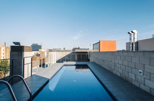 a swimming pool on the roof of a building at Barcelona Apartment Republica in Barcelona