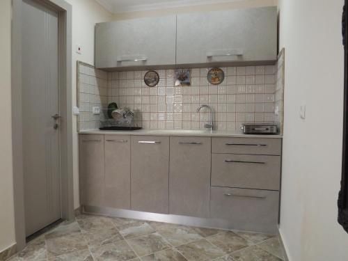 a kitchen with brown cabinets and a sink at Shahal Apartments in Beer Sheva