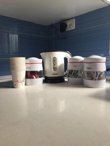 a group of coffee cups sitting on a counter at Shahal Apartments in Beer Sheva