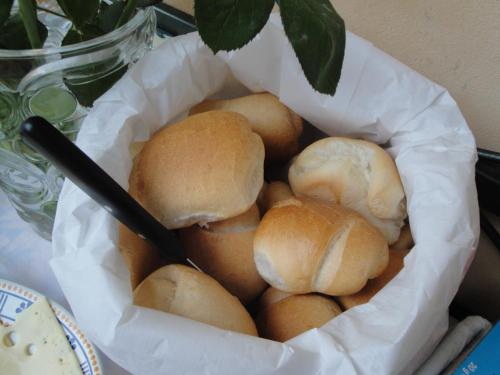 a basket filled with bread rolls in a bowl at The Tower Of The Old King in Desenzano del Garda