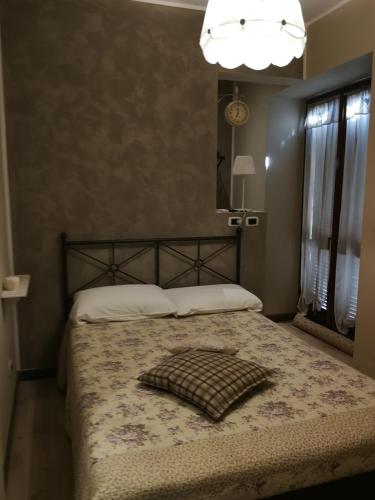 a bedroom with a bed with a pillow on it at B&B Cascina Barolo in Turin