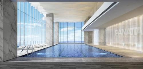 a swimming pool in a hotel lobby with a view of the city at The Clouds Apartment in Shenzhen