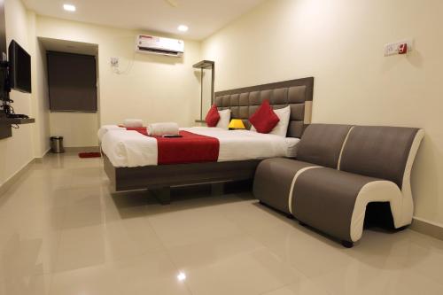 a bedroom with a large bed and a couch at Venture Park, OMR, Thoraipakkam, Chennai in Chennai