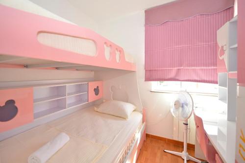 a childs bedroom with a pink bunk bed at Fashion Beach Apartments in Risan