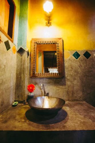 a bathroom with a wooden sink and a mirror at Sawasdeepai River Resort in Pai