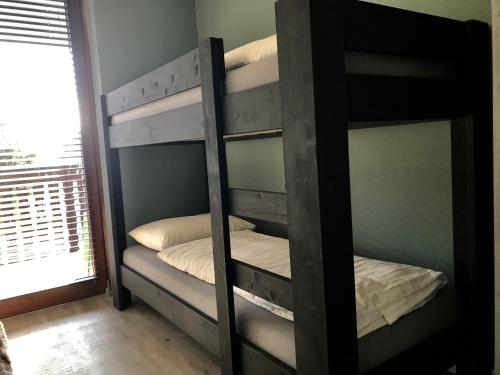 two bunk beds in a room with a window at Kappeberg Lodge in Winterberg