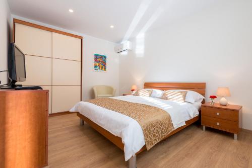 1 dormitorio con 1 cama y TV en Apartment Eden, en Dubrovnik