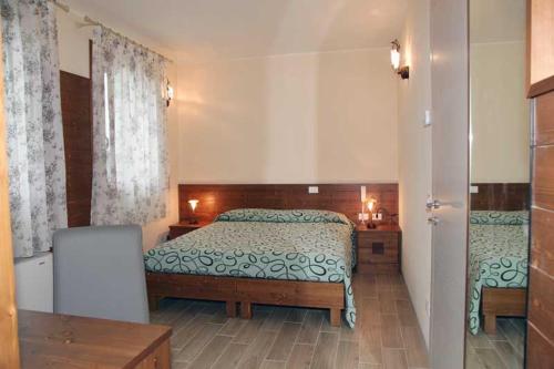 Ένα ή περισσότερα κρεβάτια σε δωμάτιο στο Azienda Agrituristica Ai Prai