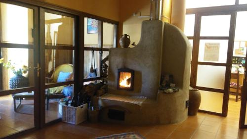 a living room with a fireplace in the middle of a room at Las Huellas de Cameros in Soto en Cameros