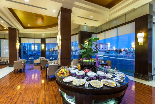 a dining room with a table with plates of food at Boudl Taif in Taif