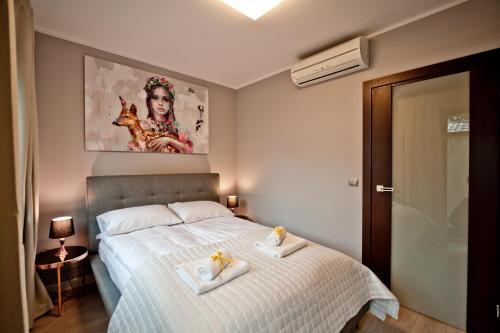 a bedroom with a bed with two towels on it at Villa Aqua BlueApart Jurata in Jurata